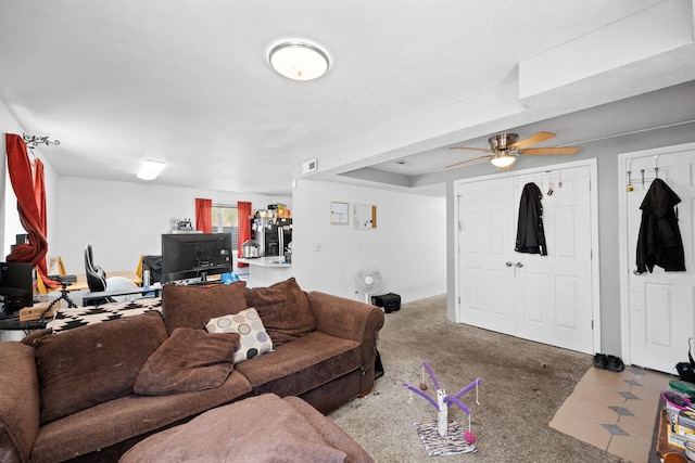 carpeted living room with visible vents and a ceiling fan