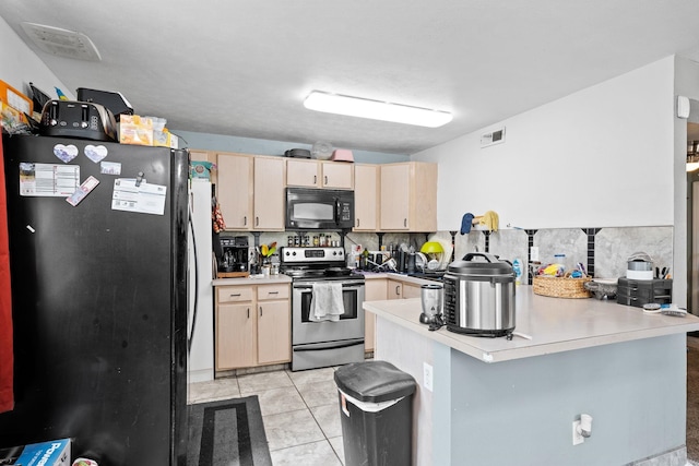 kitchen featuring light tile patterned floors, light brown cabinets, a peninsula, decorative backsplash, and black appliances