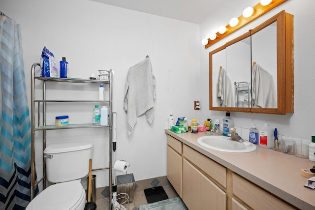 bathroom featuring toilet and vanity