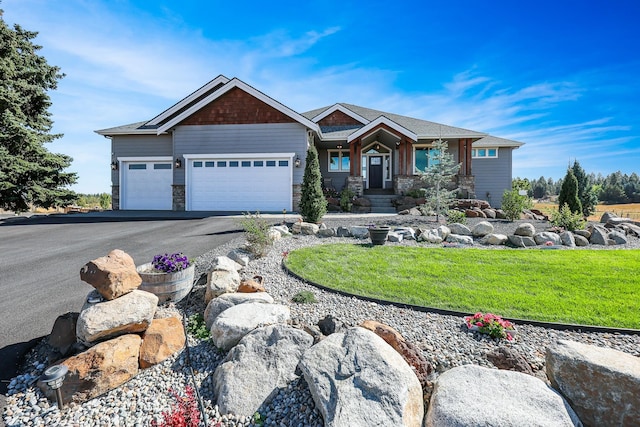 craftsman house with stone siding, aphalt driveway, a front lawn, and an attached garage