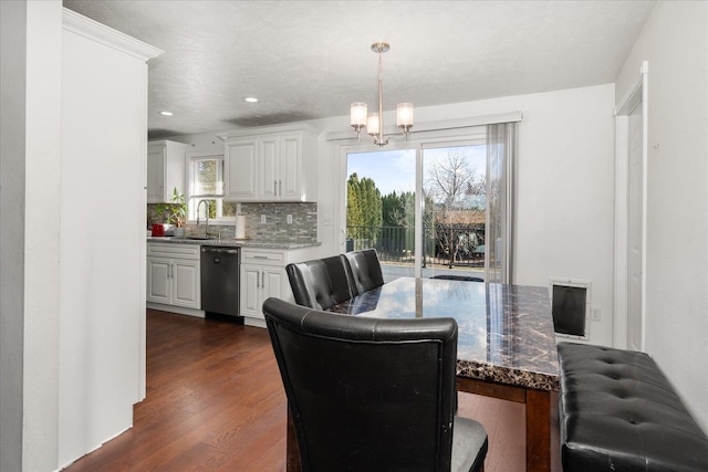 dining room with dark wood-style floors, recessed lighting, a notable chandelier, and plenty of natural light