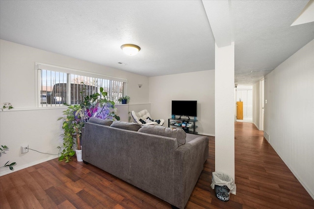 living room with a textured ceiling and wood finished floors