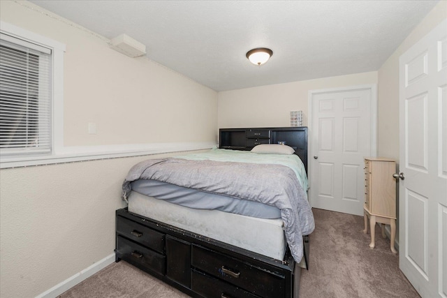 carpeted bedroom featuring baseboards