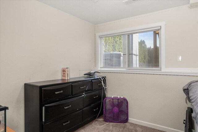 carpeted bedroom featuring baseboards