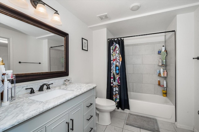 bathroom featuring toilet, visible vents, vanity, tile patterned floors, and shower / bath combo with shower curtain