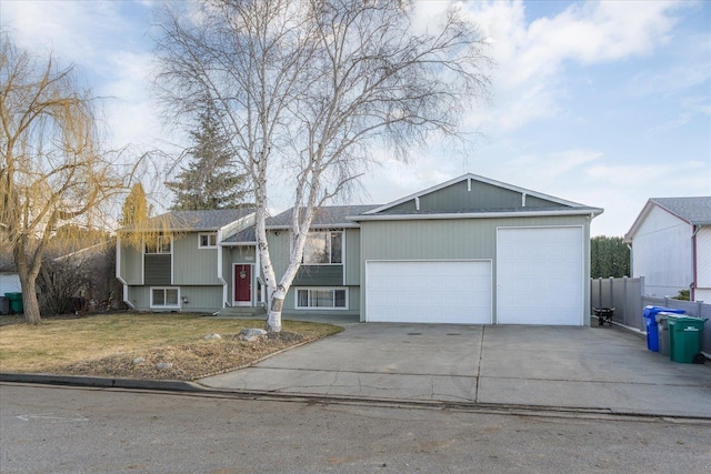 view of front facade featuring a garage, concrete driveway, a front yard, and fence