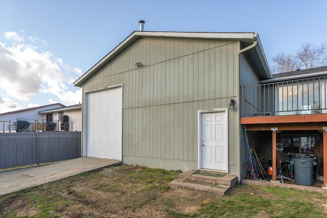 back of property featuring an outdoor structure and fence