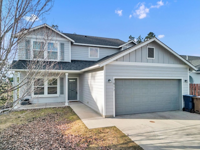 traditional-style house featuring an attached garage, driveway, board and batten siding, and roof with shingles