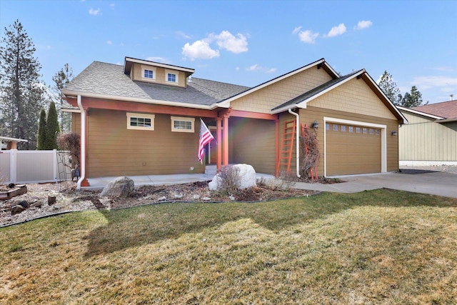 view of front of house with a shingled roof, a front yard, fence, a garage, and driveway