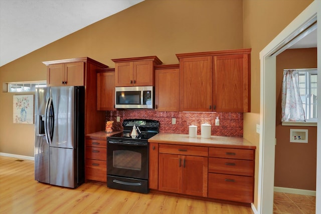 kitchen featuring appliances with stainless steel finishes, brown cabinets, backsplash, and baseboards