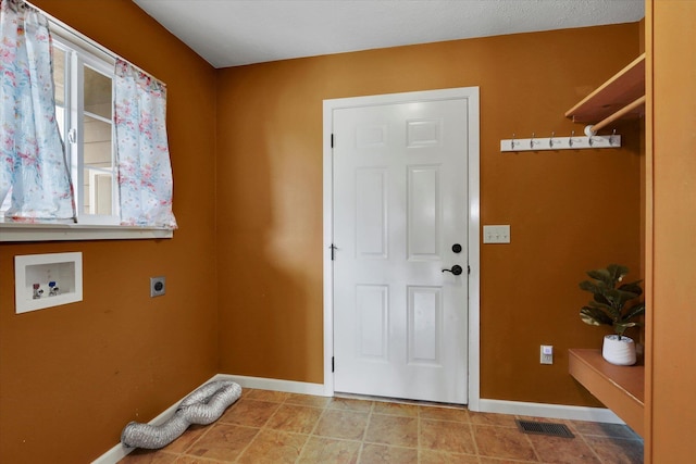 laundry area featuring baseboards, laundry area, hookup for a washing machine, and hookup for an electric dryer