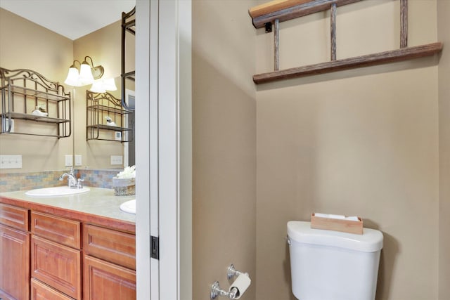 bathroom with tasteful backsplash, vanity, and toilet