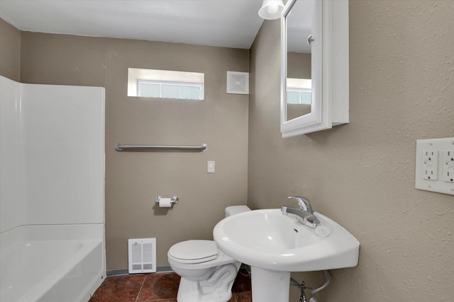 bathroom with baseboards, visible vents, toilet,  shower combination, and a sink