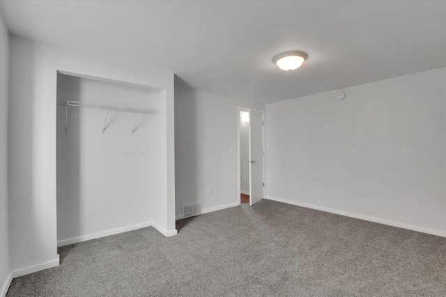 unfurnished bedroom with a closet, baseboards, visible vents, and carpet flooring