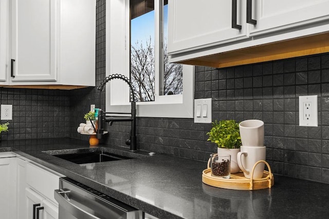 kitchen with dishwasher, white cabinetry, decorative backsplash, and a sink