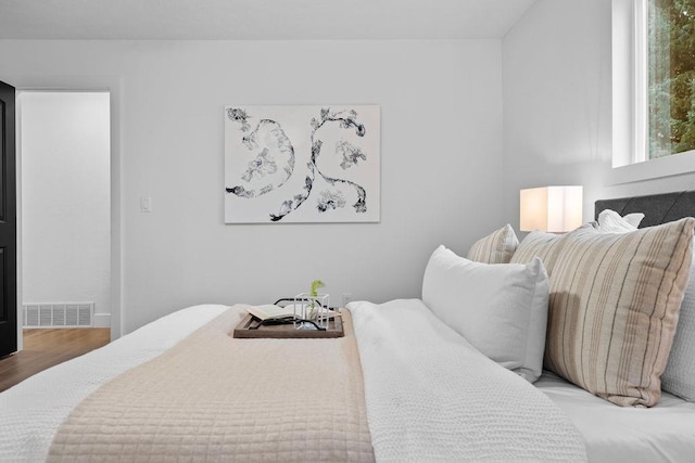 bedroom with visible vents and wood finished floors