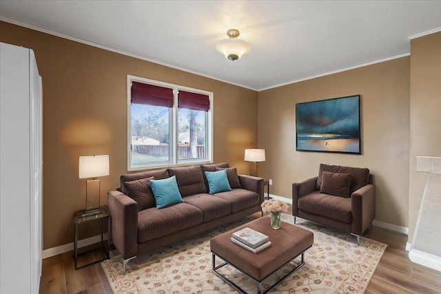 living area featuring light wood finished floors, baseboards, and ornamental molding