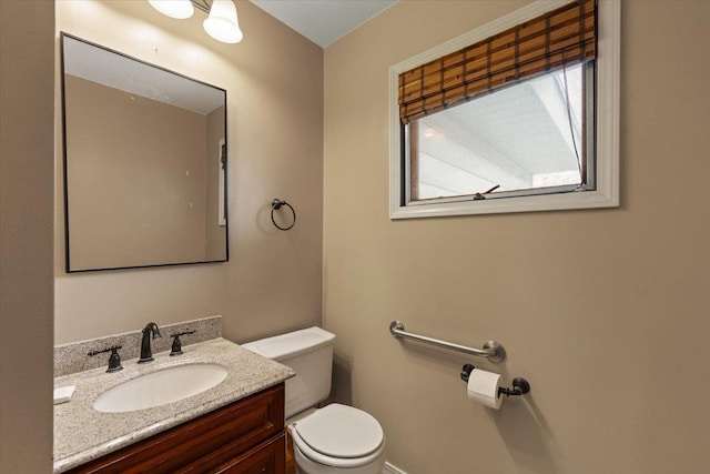 bathroom featuring toilet and vanity