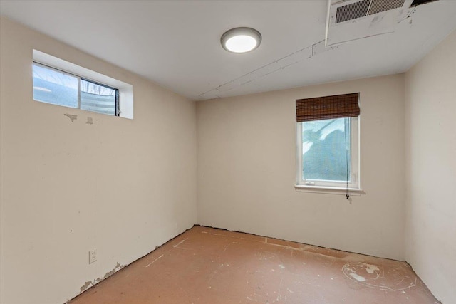 unfurnished room with visible vents