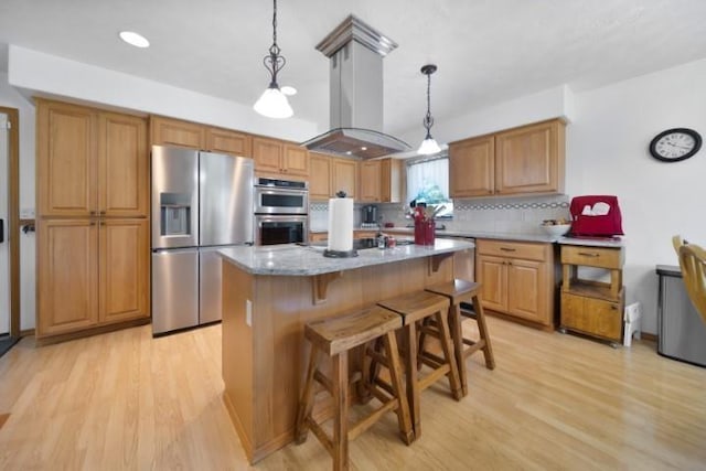 kitchen featuring light wood finished floors, appliances with stainless steel finishes, island exhaust hood, pendant lighting, and backsplash