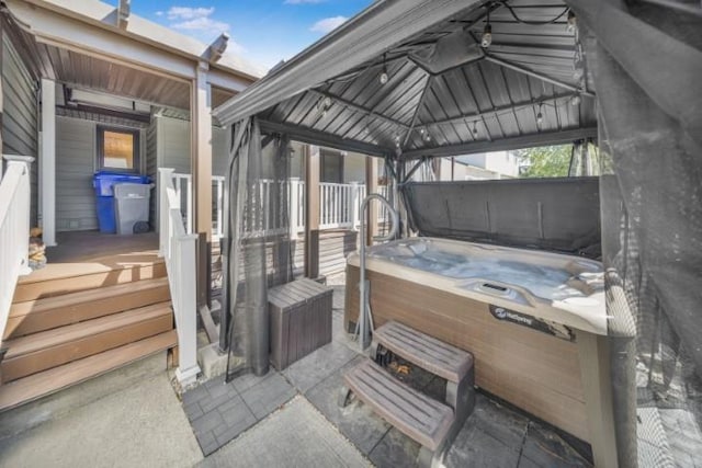 view of patio / terrace with a gazebo and a hot tub