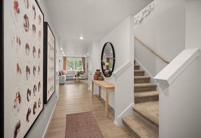 interior space with baseboards, stairway, light wood-type flooring, and recessed lighting