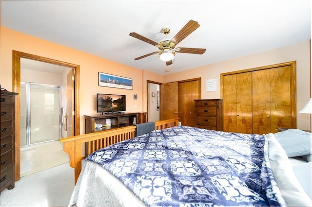 bedroom with a ceiling fan and two closets