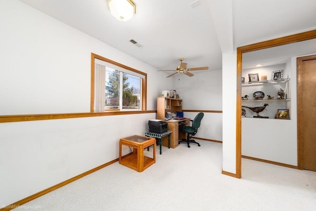 carpeted home office with ceiling fan, visible vents, and baseboards