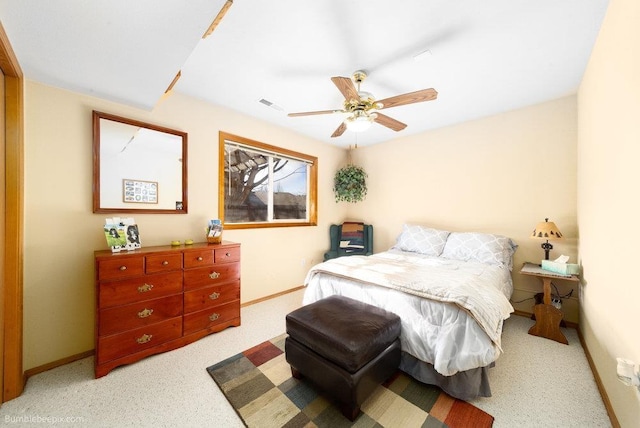 bedroom with carpet flooring, visible vents, ceiling fan, and baseboards