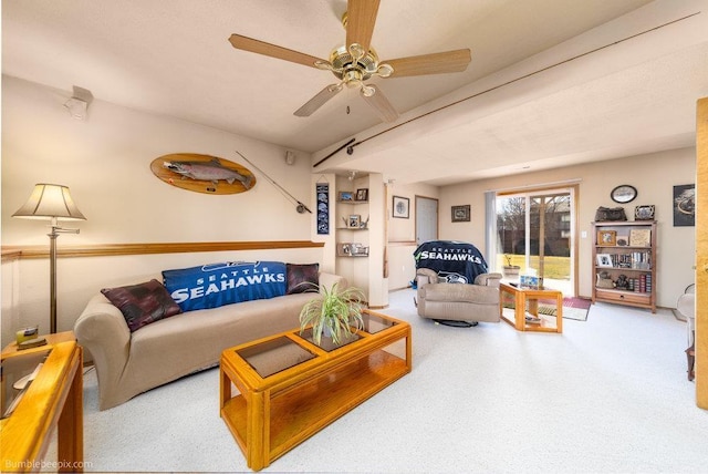 carpeted living area with ceiling fan