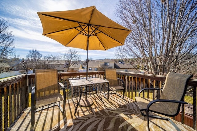 wooden deck featuring a residential view and outdoor dining space