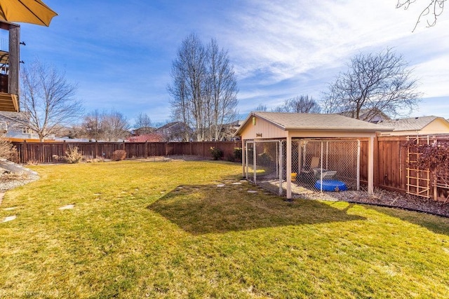 view of yard with an outbuilding and a fenced backyard