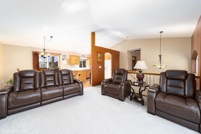 living area featuring lofted ceiling, light carpet, arched walkways, and an inviting chandelier