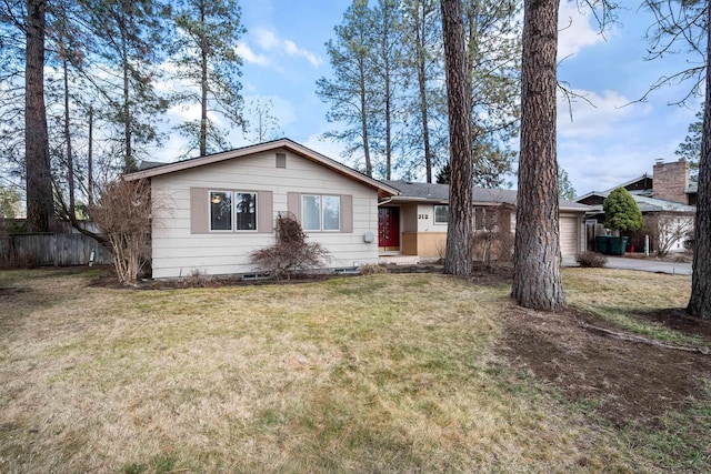 single story home with a garage, a front yard, and fence