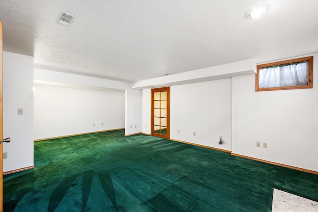 carpeted empty room with baseboards and visible vents