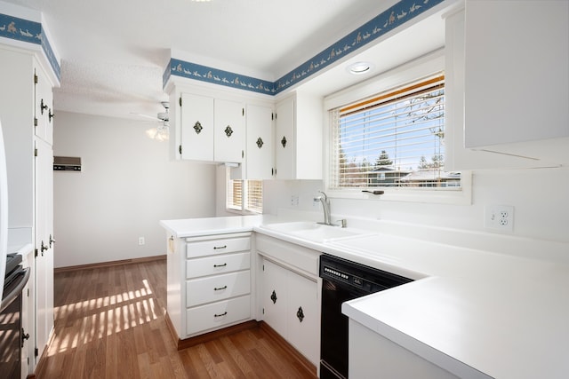 kitchen featuring wood finished floors, a sink, white cabinetry, black dishwasher, and stainless steel range with electric cooktop