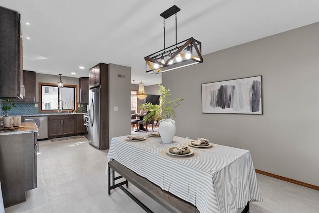 dining room with baseboards and recessed lighting