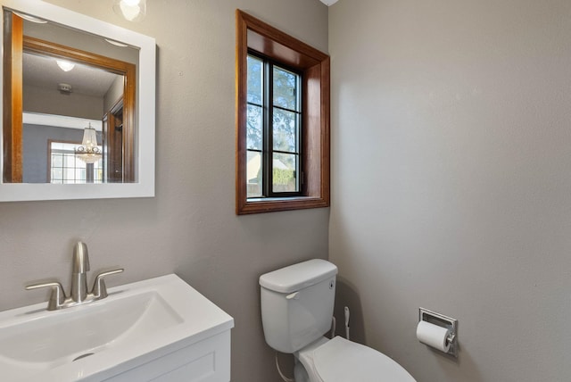 bathroom featuring toilet and vanity