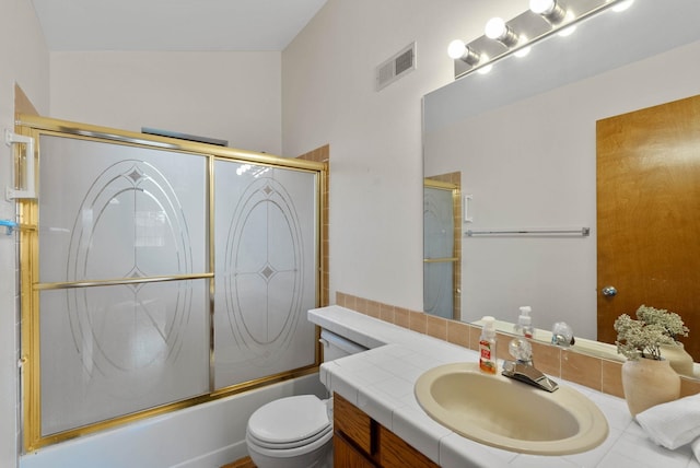 full bath with visible vents, shower / bath combination with glass door, vanity, and toilet