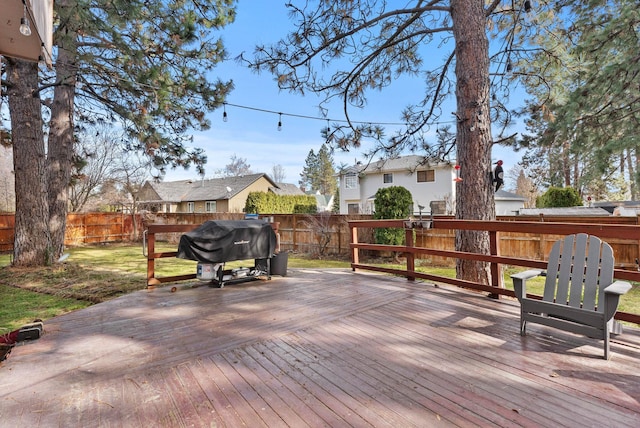 deck featuring a fenced backyard and a grill