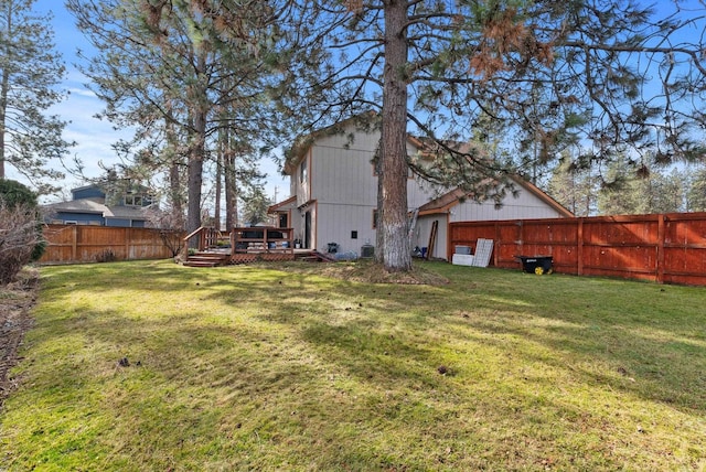 view of yard with a fenced backyard and a wooden deck