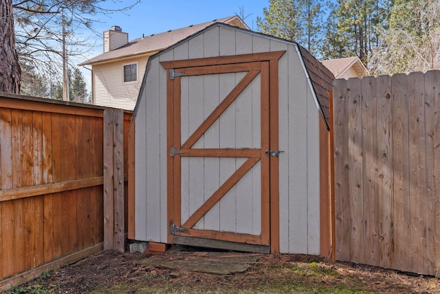 view of shed featuring fence