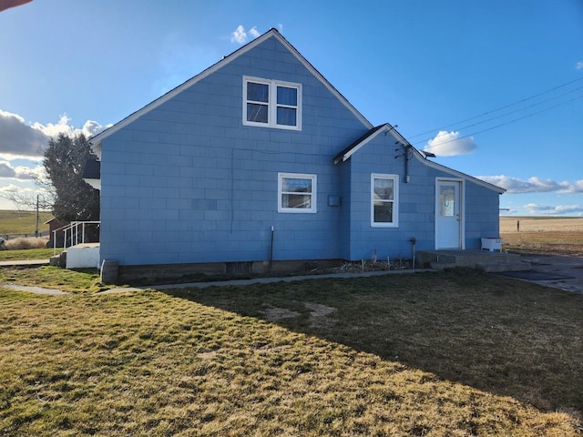 rear view of house with a yard