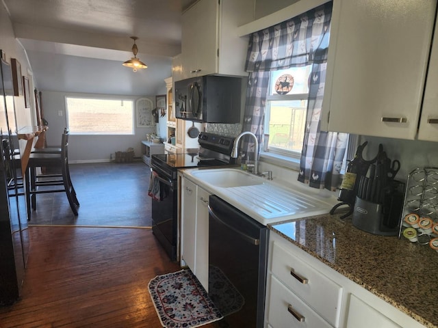 kitchen featuring white cabinets, black appliances, dark wood-type flooring, and a sink