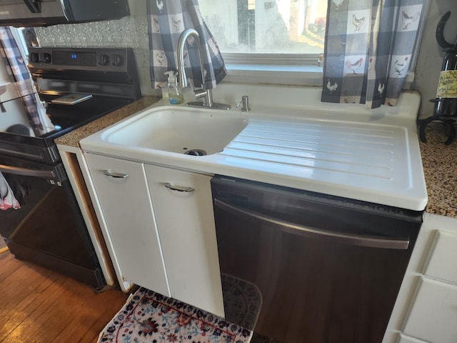 kitchen featuring stainless steel dishwasher, white cabinetry, a sink, wood finished floors, and black range with electric cooktop