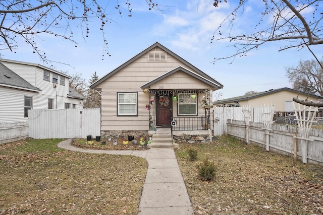 bungalow featuring a porch and fence