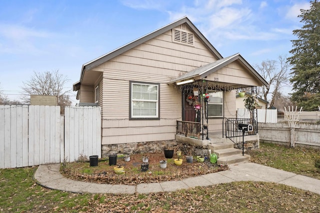 bungalow with covered porch and fence