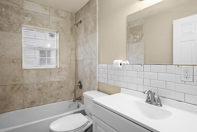 bathroom featuring toilet, vanity, tile walls,  shower combination, and decorative backsplash