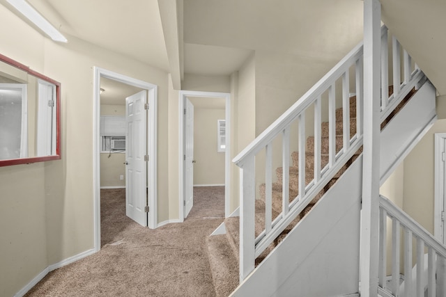 stairs with carpet floors and baseboards