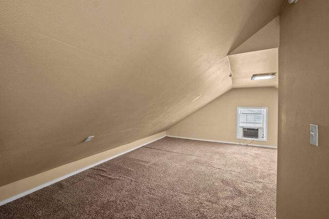 additional living space featuring vaulted ceiling, cooling unit, carpet flooring, and baseboards